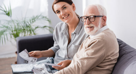 adult woman sitting on the couch with elderly man