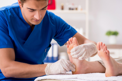 health worker massaging feet of patient
