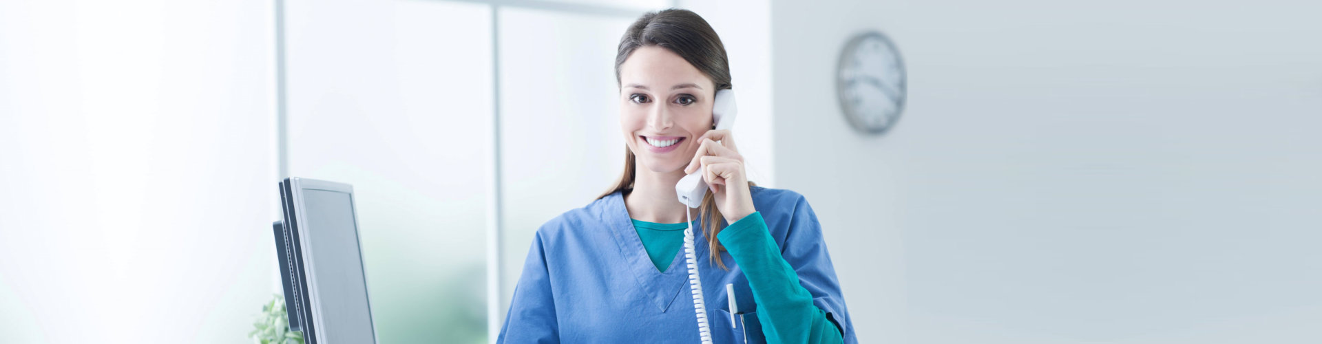 nurse smiling while on the phone